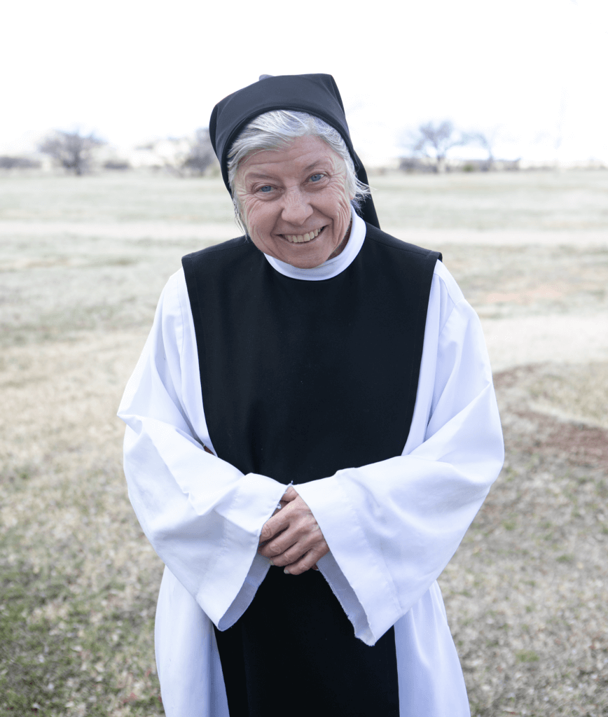 A nun is standing outside of her monastery in Arizona